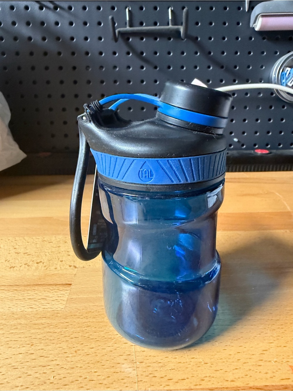 Blue Plastic TAL Sports Water Bottle with Flip Lid and carry handle.
